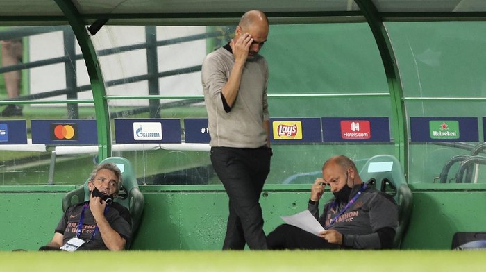 Manchester Citys head coach Pep Guardiola reacts during the Champions League quarterfinal soccer match between Lyon and Manchester City at the Jose Alvalade stadium in Lisbon, Portugal, Saturday, Aug. 15, 2020. (Miguel A. Lopes/Pool via AP)