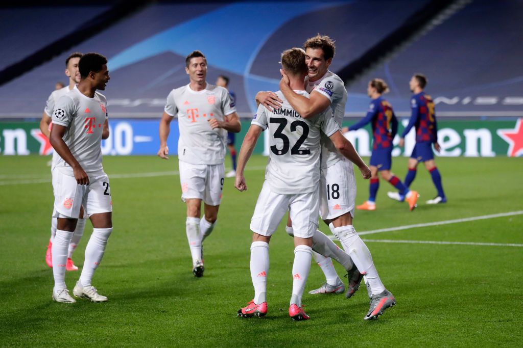 LISBON, PORTUGAL - AUGUST 14: Joshua Kimmich of FC Bayern Munich celebrates with teammate Leon Goretzka after scoring his team's fifth goal during the UEFA Champions League Quarter Final match between Barcelona and Bayern Munich at Estadio do Sport Lisboa e Benfica on August 14, 2020 in Lisbon, Portugal. (Photo by Manu Fernandez/Pool via Getty Images)