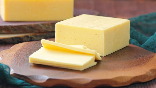 Piece of cheese on the wooden table