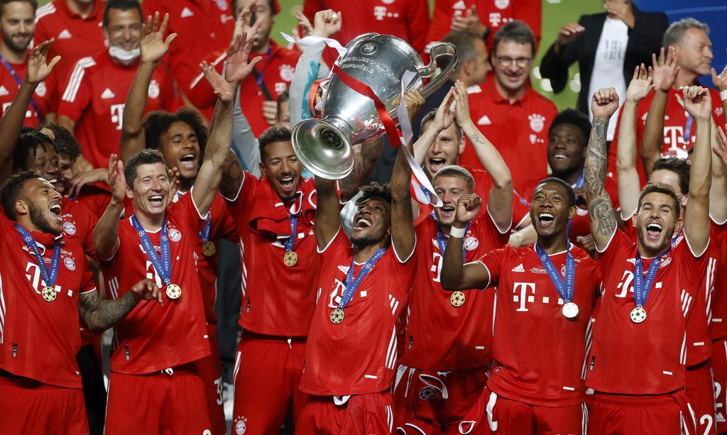 Bayern's Kingsley Coman lifts the trophy after Munich won the Champions League final soccer match between Paris Saint-Germain and Bayern Munich at the Luz stadium in Lisbon, Portugal, Sunday, Aug. 23, 2020.(Matthew Childs/Pool via AP)
