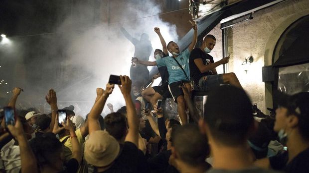 Fans celebrate a goal by Bayern Munich, Sunday Aug. 23, 2020 in Marseille, southern France, during the Champions League final soccer match between Paris Saint-Germain and Bayern Munich being played at the Luz stadium in Lisbon, Portugal.(AP Photo/Daniel Cole)