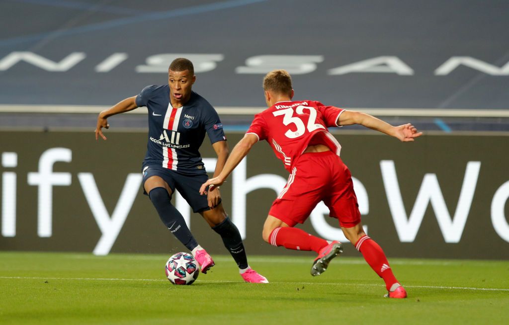 LISBON, PORTUGAL - AUGUST 23: Kylian Mbappe of Paris Saint-Germain takes on Joshua Kimmich of FC Bayern Munich during the UEFA Champions League Final match between Paris Saint-Germain and Bayern Munich at Estadio do Sport Lisboa e Benfica on August 23, 2020 in Lisbon, Portugal. (Photo by Miguel A. Lopes/Pool via Getty Images)