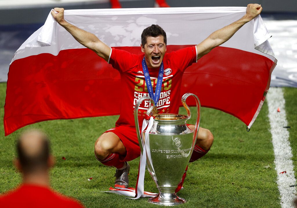 Bayern's Robert Lewandowski celebrates with the trophy after Munich won the Champions League final soccer match between Paris Saint-Germain and Bayern Munich at the Luz stadium in Lisbon, Portugal, Sunday, Aug. 23, 2020.(Matthew Childs/Pool via AP)