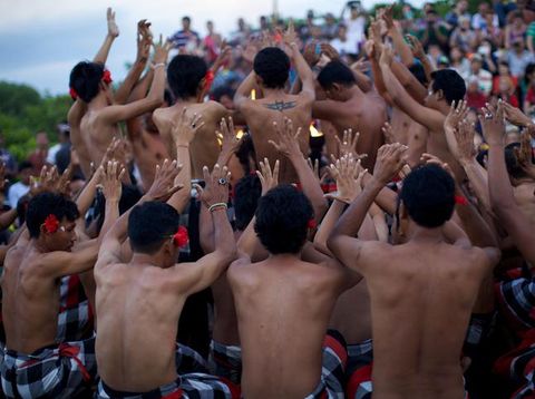 Bali, Indonesia - June 5, 2022: Traditional Ritual Balinese Kecak dance with elements of trance performed by men artists in traditional costumes  at Uluwatu Temple in the evening.