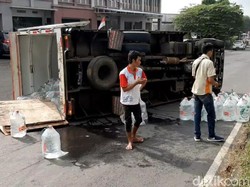 Pecah Ban, Mobil Boks Muatan Galon Air Mineral Terguling di Tasik