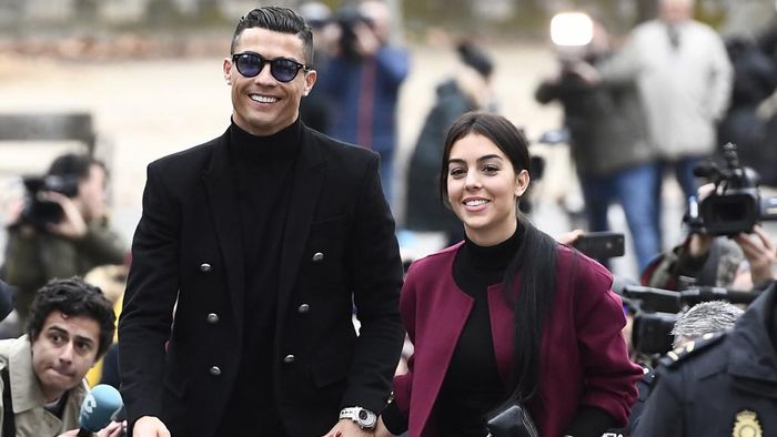 Ronaldo Georgina Juventus forward and former Real Madrid player Cristiano Ronaldo arrives with his Spanish girlfriend Georgina Rodriguez to attend a court hearing for tax evasion in Madrid on January 22, 2019. - Ronaldo is expected to be given a hefty fine after Spanish tax authorities and the players advisors made a deal to settle claims he hid income generated from image rights when he played for Real Madrid. (Photo by PIERRE-PHILIPPE MARCOU / AFP)