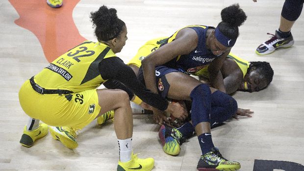 Seattle Storm forwards Alysha Clark (32) and Natasha Howard, right, battle Indiana Fever forward Kennedy Burke for possession during the second half of a WNBA basketball game, Tuesday, Aug. 25, 2020, in Bradenton, Fla. (AP Photo/Phelan M. Ebenhack)