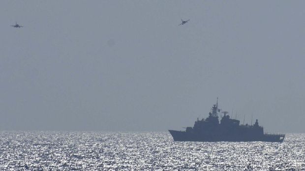 In this photo provided by the Greek Defense Ministry, air force jets and a warship take part in a military exercise in Eastern Mediterranean sea, on Tuesday, Aug. 25, 2020. Germany's foreign minister appealed to NATO allies Greece and Turkey to deescalate military tensions in the eastern Mediterranean, warning Tuesday that 