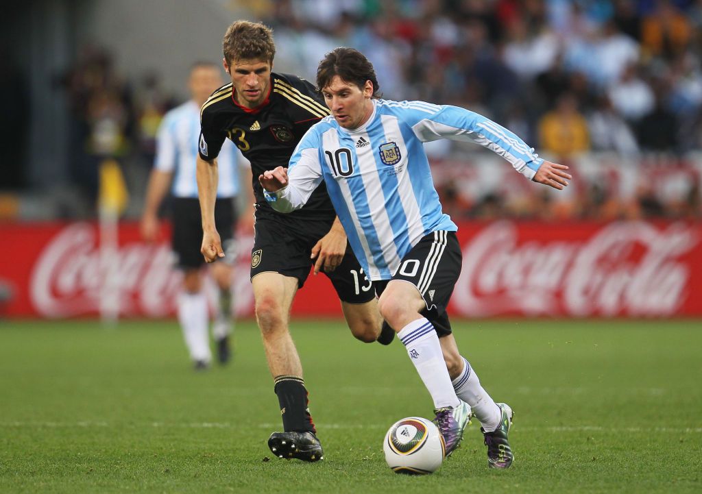 CAPE TOWN, SOUTH AFRICA - JULY 03:  Lionel Messi of Argentina is pursued by Thomas Mueller of Germany during the 2010 FIFA World Cup South Africa Quarter Final match between Argentina and Germany at Green Point Stadium on July 3, 2010 in Cape Town, South Africa.  (Photo by Chris McGrath/Getty Images)