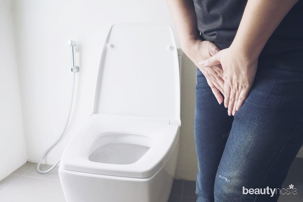 woman-holding-hand-near-toilet-bowl-health-problem-concept