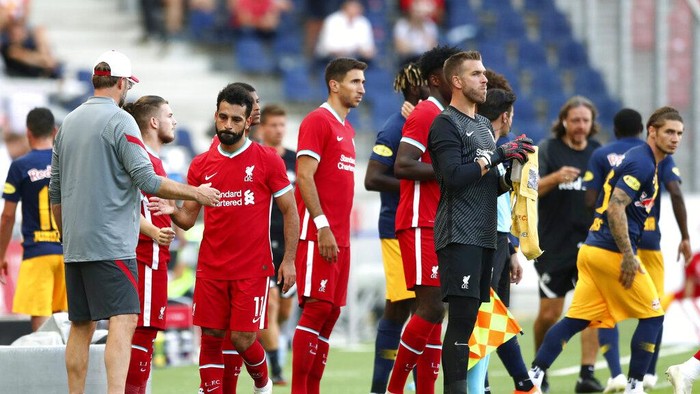 Liverpools manager Juergen Klopp, left, shake hands with Liverpools Mohamed Salah during a friendly soccer match between RB Salzburg and FC Liverpool in Salzburg, Austria, Tuesday, Aug. 25, 2020. (AP Photo/Matthias Schrader)