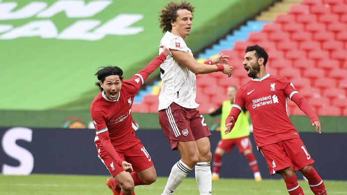Liverpools Takumi Minamino, left, celebrates after scoring his sides first goal during the English FA Community Shield soccer match between Arsenal and Liverpool at Wembley stadium in London, Saturday, Aug. 29, 2020. (Justin Tallis/Pool via AP)