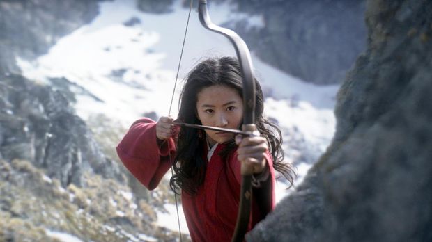 Film Review - Mulan This image released by Disney shows Yifei Liu, center, in the title role of