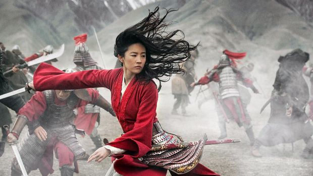 This image released by Disney shows Yifei Liu, center, in the title role of 