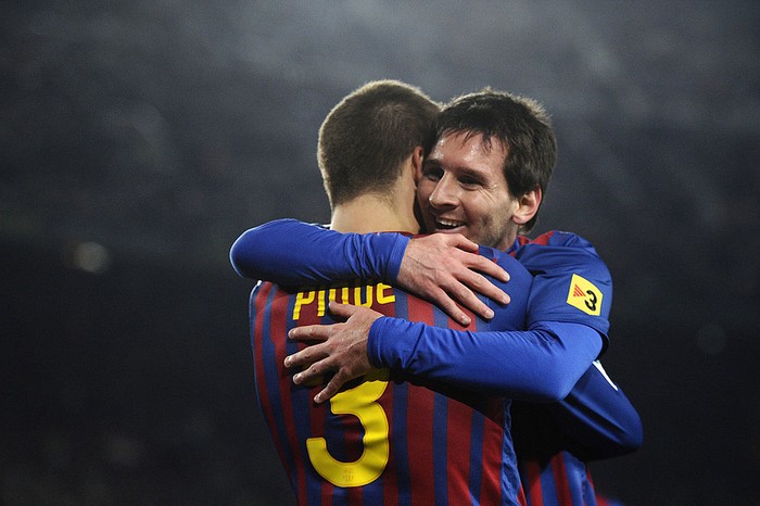 BARCELONA, SPAIN - JANUARY 04:  Lionel Messi of FC Barcelona (R)  celebrates with his teammate Gerard Pique of FC Barcelona after scoring his teams third goal during the round of last 16 Copa del Rey 1st leg match between FC Barcelona and CZ Osasuna at Camp Nou on January 4, 2012 in Barcelona, Spain.  (Photo by David Ramos/Getty Images)