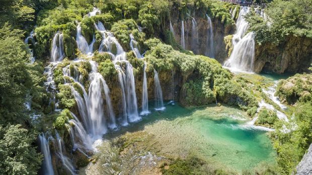 Tourists overlooking the beautiful Waterfalls, Plitvice Lakes National Park, Croatia. Nikon D850. Converted from RAW.