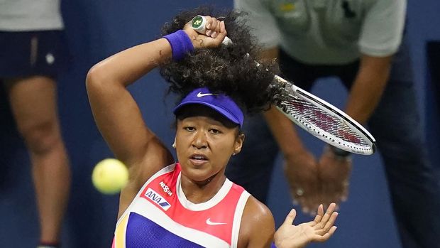 Naomi Osaka, of Japan, returns a shot to Camila Giorgi, of Italy, during the second round of the U.S. Open tennis championships, Wednesday, Sept. 2, 2020, in New York. (AP Photo/Frank Franklin II)