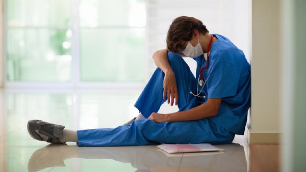 Worried female doctor looking through the window