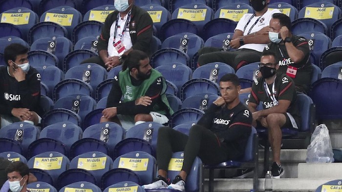Portugals Cristiano Ronaldo, foreground right, watches form the stands the UEFA Nations League soccer match between Portugal and Croatia at the Dragao stadium in Porto, Portugal, Saturday, Sept. 5, 2020. Ronaldo is not playing due to an injury. (AP Photo/Miguel Angelo Pereira)