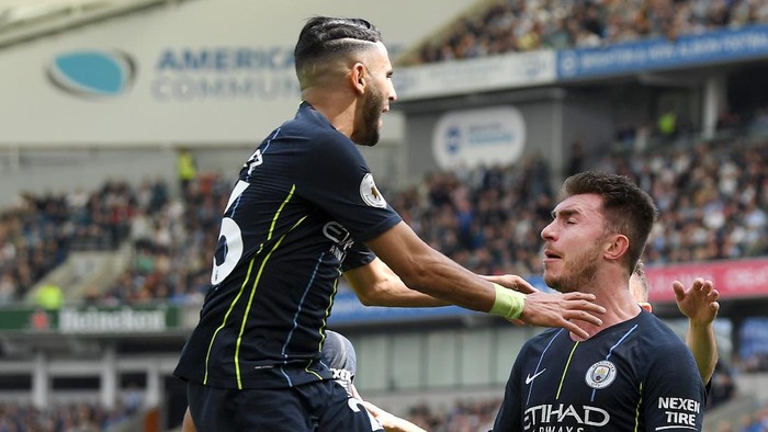 BRIGHTON, ENGLAND - MAY 12: Aymeric Laporte of Manchester City celebrates with teammate Riyad Mahrez after scoring his teams second goal during the Premier League match between Brighton & Hove Albion and Manchester City at American Express Community Stadium on May 12, 2019 in Brighton, United Kingdom. (Photo by Mike Hewitt/Getty Images)