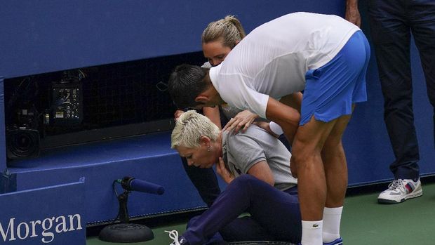 Novak Djokovic, of Serbia, checks a linesman after hitting her with a ball in reaction to losing a point to Pablo Carreno Busta, of Spain, during the fourth round of the US Open tennis championships, Sunday, Sept. 6, 2020, in New York. Djokovic defaulted the match. (AP Photo/Seth Wenig)