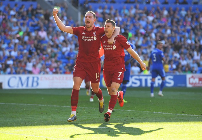 CARDIFF, WALES - APRIL 21:  James Milner of Liverpool celebrates after scoring his teams second goal with teammate Jordan Henderson during the Premier League match between Cardiff City and Liverpool FC at Cardiff City Stadium on April 21, 2019 in Cardiff, United Kingdom. (Photo by Mike Hewitt/Getty Images)