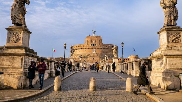 Lungotevere Rome, Italy, February 27 -- A warm sunset on Castel Sant'Angelo facade, near the Vatican and St. Peter's Basilica, and the Lungotevere (Way Along the Tiber). Built around 123 AD as a sepulcher for Emperor Hadrian and his family, the current Castel Sant'Angelo was used as a fortress, prison and refuge by the Popes'. It is currently owned by the Italian State and is used for visits and cultural events. Image in HD format.