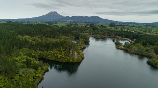Overhead view of Mt Taranaki overlooking through lake in New Zealand.