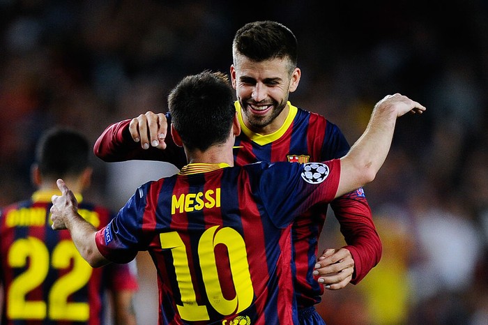 BARCELONA, SPAIN - SEPTEMBER 18:  Lionel Messi of FC Barcelona celebrates with his team-mate Gerard Pique after scoring his teams fourth goal during the UEFA Champions League Group H match between FC Barcelona and Ajax Amsterdam ag the Camp Nou stadium on September 18, 2013 in Barcelona, Spain.  (Photo by David Ramos/Getty Images)