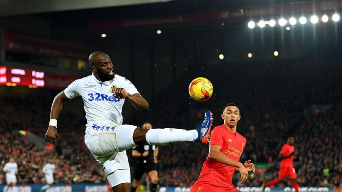 LIVERPOOL, ENGLAND - NOVEMBER 29:  Souleymane Doukara of Leeds United clears the ball from Trent Alexander-Arnold of Liverpool during the EFL Cup Quarter-Final match between Liverpool and Leeds United at Anfield on November 29, 2016 in Liverpool, England.  (Photo by Laurence Griffiths/Getty Images)