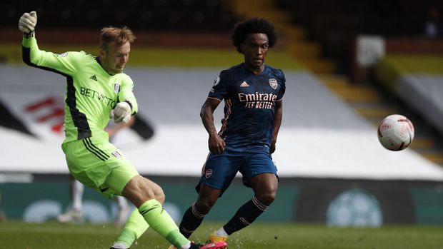 Fulham's goalkeeper Marek Rodak, left, kicks the ball past Arsenal's Willian during the English Premier League soccer match between Fulham and Arsenal in London, Saturday, Sept. 12, 2020. (Paul Childs/Pool via AP)