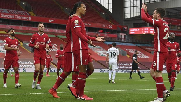 Liverpool's Virgil van Dijk, center, celebrates with his teammates after he scored his side's second goal during the English Premier League soccer match between Liverpool and Leeds United, at the Anfield stadium, in Liverpool, Saturday, Sept. 12, 2020. (Paul Ellis, Pool via AP)