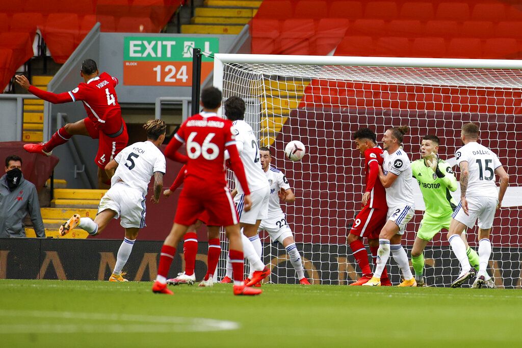 Liverpool's Virgil van Dijk, left, scores his side's second goal during the English Premier League soccer match between Liverpool and Leeds United, at the Anfield stadium, in Liverpool, Saturday, Sept. 12, 2020. (Phil Noble, Pool via AP)