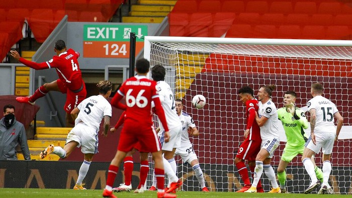 Liverpools Virgil van Dijk, left, scores his sides second goal during the English Premier League soccer match between Liverpool and Leeds United, at the Anfield stadium, in Liverpool, Saturday, Sept. 12, 2020. (Phil Noble, Pool via AP)