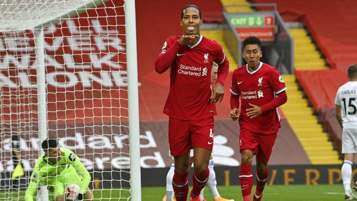 Liverpools Virgil van Dijk, center, celebrates after he scored his sides second goal during the English Premier League soccer match between Liverpool and Leeds United, at the Anfield stadium, in Liverpool, Saturday, Sept. 12, 2020. (Paul Ellis, Pool via AP)