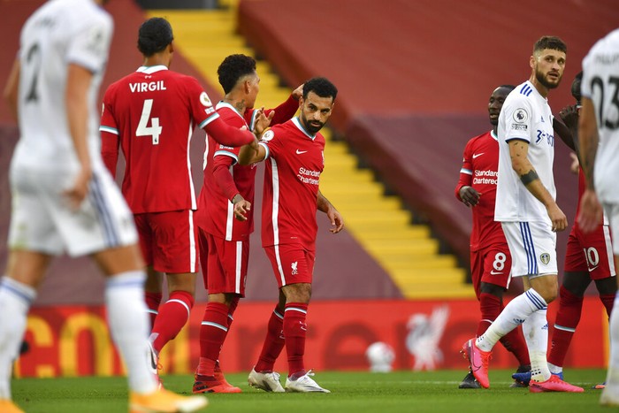 Liverpools Mohamed Salah, center, celebrates with his teammates after he scored his sides third goal during the English Premier League soccer match between Liverpool and Leeds United, at the Anfield stadium, in Liverpool, Saturday, Sept. 12, 2020. (Paul Ellis, Pool via AP)