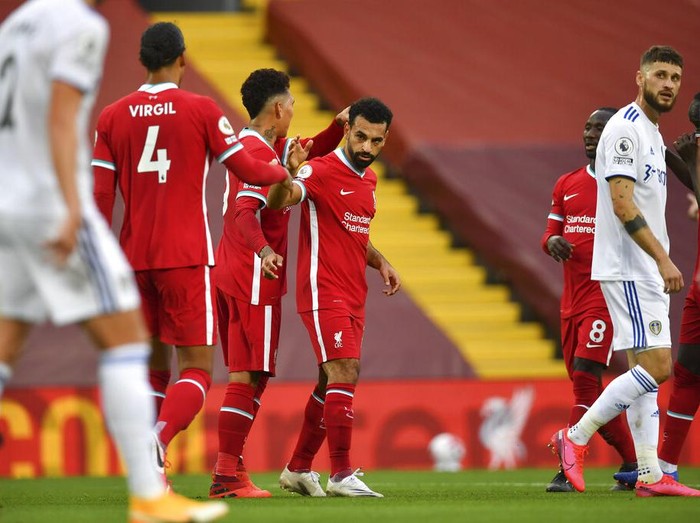 Liverpools Mohamed Salah, center, celebrates with his teammates after he scored his sides third goal during the English Premier League soccer match between Liverpool and Leeds United, at the Anfield stadium, in Liverpool, Saturday, Sept. 12, 2020. (Paul Ellis, Pool via AP)