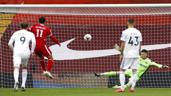 Liverpools Mohamed Salah, second from left, scores his sides first goal on a penalty kick during the English Premier League soccer match between Liverpool and Leeds United, at the Anfield stadium, in Liverpool, Saturday, Sept. 12, 2020. (Phil Noble, Pool via AP)