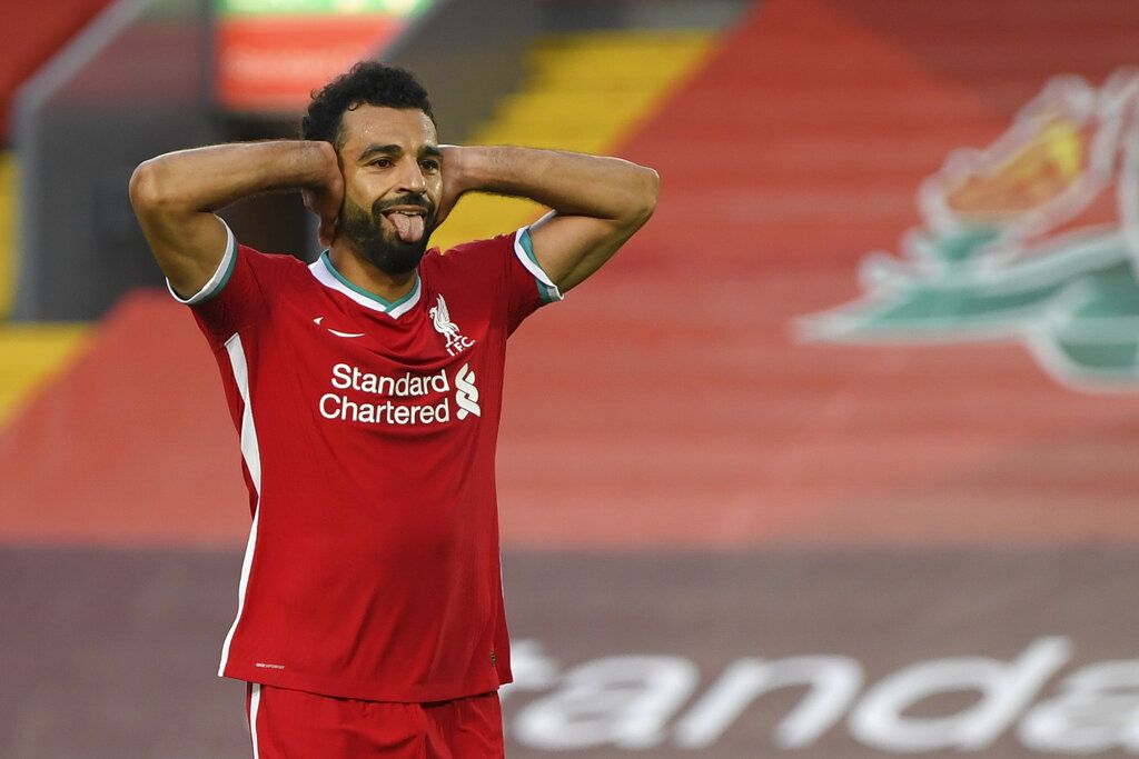 Liverpool's Mohamed Salah celebrates after he scored his side's fourth goal during the English Premier League soccer match between Liverpool and Leeds United, at the Anfield stadium, in Liverpool, Saturday, Sept. 12, 2020. (Shaun Botterill, Pool via AP)