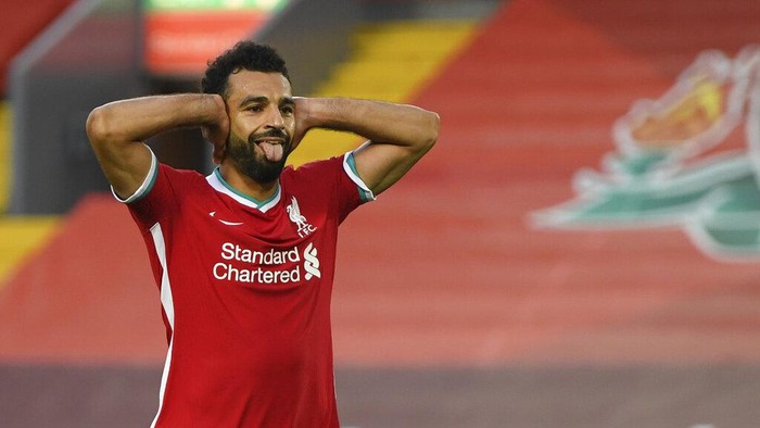 Liverpools Mohamed Salah celebrates after he scored his sides fourth goal during the English Premier League soccer match between Liverpool and Leeds United, at the Anfield stadium, in Liverpool, Saturday, Sept. 12, 2020. (Shaun Botterill, Pool via AP)