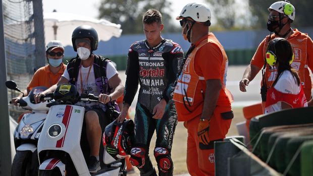 MotoGP rider Fabio Quartararo of France walks away from the track after crashing during the San Marino Motorcycle Grand Prix at the Misano circuit in Misano Adriatico, Italy, Sunday, Sept. 13, 2020. (AP Photo/Antonio Calanni)