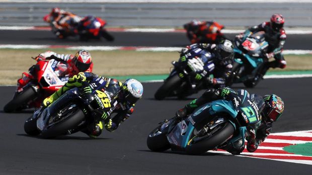 MotoGP rider Franco Morbidelli of Italy, right, takes a curve followed by Valentino Rossi of Italy at the start of the San Marino Motorcycle Grand Prix at the Misano circuit in Misano Adriatico, Italy, Sunday, Sept. 13, 2020. (AP Photo/Antonio Calanni)