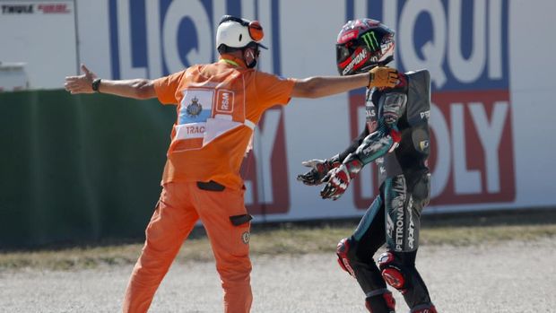 MotoGP rider Fabio Quartararo of France walks away from the track after crashing during the San Marino Motorcycle Grand Prix at the Misano circuit in Misano Adriatico, Italy, Sunday, Sept. 13, 2020. (AP Photo/Antonio Calanni)