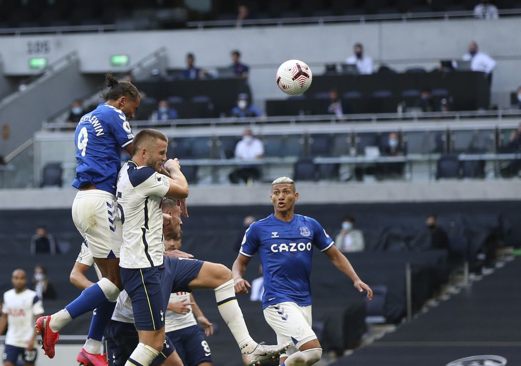 Everton's Dominic Calvert-Lewin, top, scores his side's opening goal during the English Premier League soccer match between Tottenham Hotspur and Everton at the Tottenham Hotspur Stadium in London, Sunday, Sept. 13, 2020. (Alex Pantling/Pool via AP)