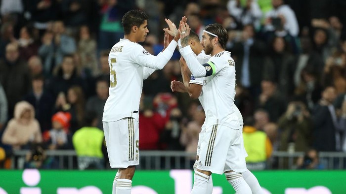 MADRID, SPAIN - NOVEMBER 06: Sergio Ramos of Real Madrid celebrates with teammate Raphael Varane after scoring his teams third goal  during the UEFA Champions League group A match between Real Madrid and Galatasaray at Bernabeu on November 06, 2019 in Madrid, Spain. (Photo by Angel Martinez/Getty Images)
