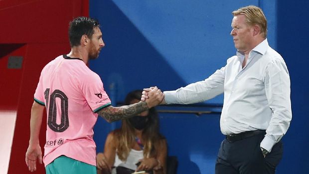 Barcelona's Lionel Messi, left, shakes hands as he is substituted with Barcelona's coach Ronald Koeman as he is substituted during the pre-season friendly soccer match between Barcelona and Girona at the Johan Cruyff Stadium in Barcelona, Spain, Wednesday, Sept. 16, 2020. (AP Photo/Joan Monfort)