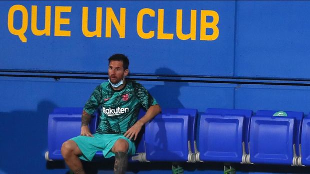 Barcelona's Lionel Messi sits on the bench during the pre-season friendly soccer match between Barcelona and Girona at the Johan Cruyff Stadium in Barcelona, Spain, Wednesday, Sept. 16, 2020. (AP Photo/Joan Monfort)