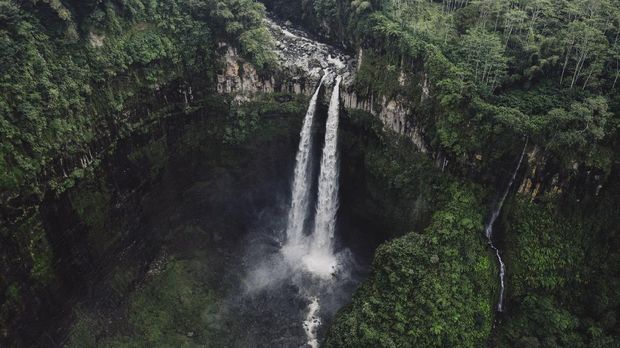 Scenic aerial view of Madakaripura waterfall in the jungles on Java, Indonesia