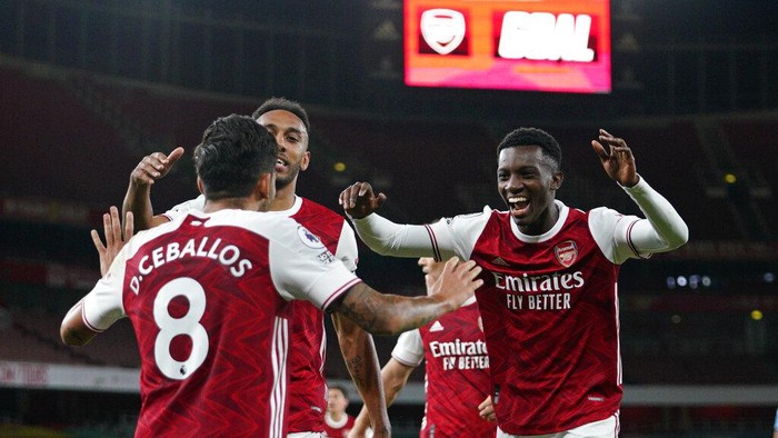 Arsenals Eddie Nketiah, right, celebrates scoring his sides second goal during the English Premier League soccer match between Arsenal and West Ham at the Emirates Stadium in London, England, Saturday, Sept. 19, 2020. (Will Oliver/Pool via AP)