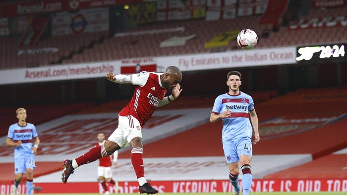 Arsenals Alexandre Lacazette scores the opening goal during the English Premier League soccer match between Arsenal and West Ham at the Emirates Stadium in London, England, Saturday, Sept. 19, 2020. (Julian Finney/Pool via AP)